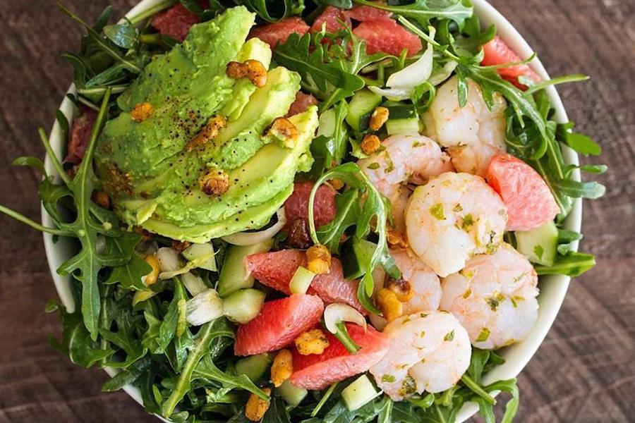 A bright, green salad with shrimp and avocado. 