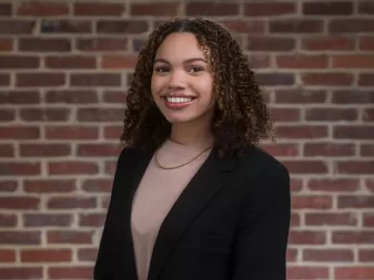 A woman smiles for a professional portrait. 