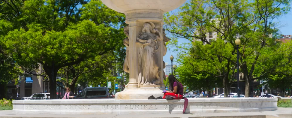 Person relaxing at Dupont Circle Monument 